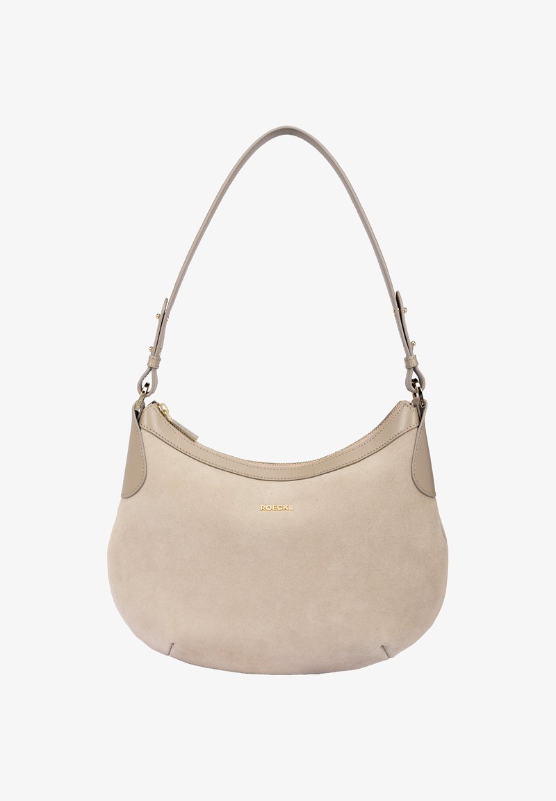 Beige suede handbag with a curved shape and a smooth leather top panel. Features a single shoulder strap and a gold logo accent.