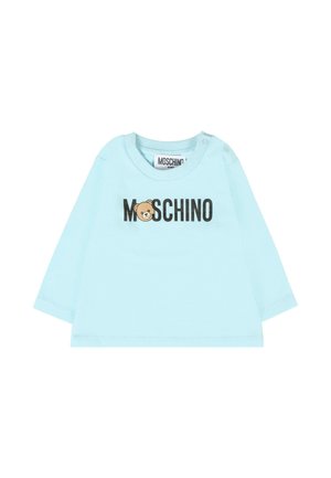 Lichtblauw katoenen overhemd met lange mouwen, versierd met een berenafbeelding en de tekst "MOSCHINO" in zwart. Inclusief schouderknopen voor gemakkelijk aan- en uitkleden.