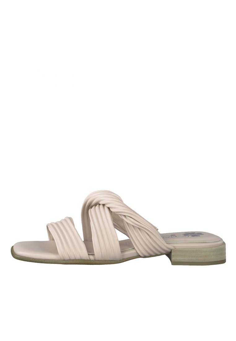 Beige slide sandal with twisted strap design, cushioned insole, and a low block heel. Smooth texture with subtle green accents.