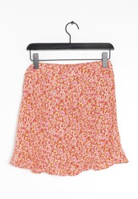 Hame flared dengan pola bunga berwarna oranye, pink, dan putih. Kain ringan dan hem sedikit berombak. Digantung dari gantungan hitam.
