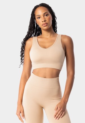 Carpatree SIMPLY SEAMLESS  - Medium support sports bra - beige