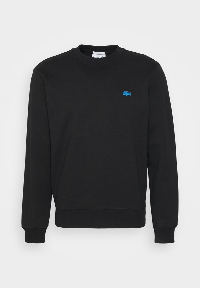 Sweat-shirt noir à manches longues avec col rond, poignets et ourlet côtelés, avec un petit logo crocodile bleu brodé sur la poitrine gauche.