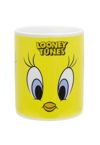 Tazza in ceramica con uno sfondo giallo brillante, raffigurante il volto di un personaggio dei cartoni animati e il logo "Looney Tunes". Texture liscia e forma arrotondata.