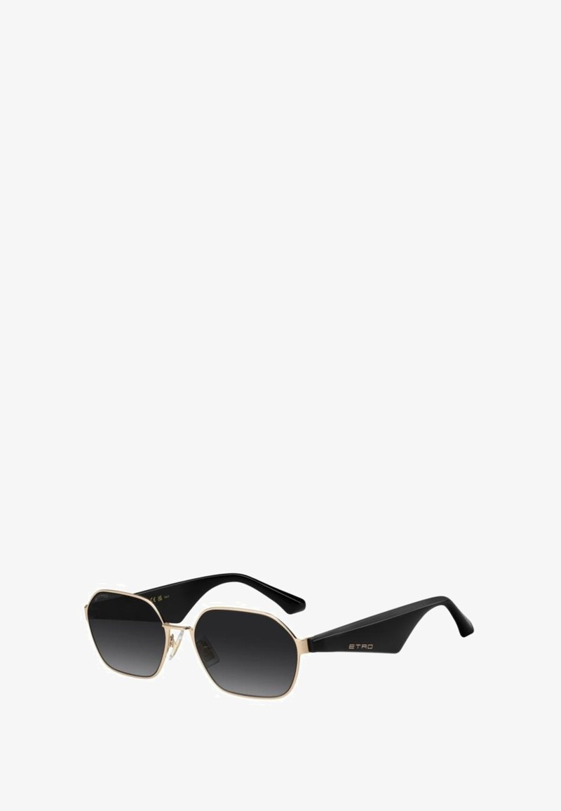 Lunettes de soleil noires et dorées à forme octogonale, verres dégradés foncés, et branches noires élégantes avec un logo sur la branche.