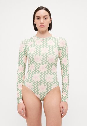 Long-sleeve swimsuit in light green with pink floral and wavy patterns. Made of stretchy fabric, featuring a high neck and form-fitting cut.