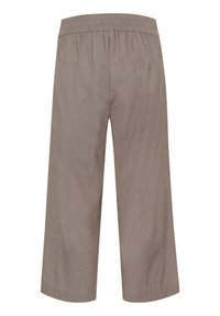 Pantalons évasés, coupés, couleur marron clair, en tissu doux avec une taille élastique et des poches latérales. Surface texturée avec une finition uniforme.