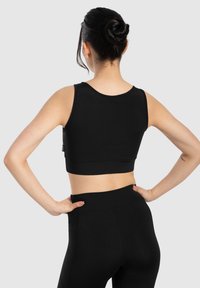 Zwarte sportieve crop top met brede banden en een gladde textuur, met een aansluitend ontwerp en een tailleband die tot het midden van de rug reikt.