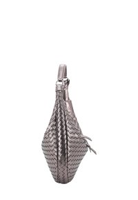 Woven metallic silver handbag with a unique elongated shape, featuring a single adjustable strap and subtle fringe accents.