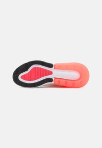 Shoe sole with a black, white, and bright pink color scheme; features a textured rubber surface and segmented cushioning for grip and flexibility.