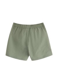 Kort olivgröna shorts med elastisk midja, med en texturerad tygkvalitet och lös passform, designade för bekväm användning.