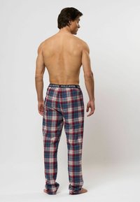 Geruite pyjamabroek in rood, blauw en wit; elastische tailleband met "POLO ASSN." label; lichtgewicht stof met een gladde textuur.