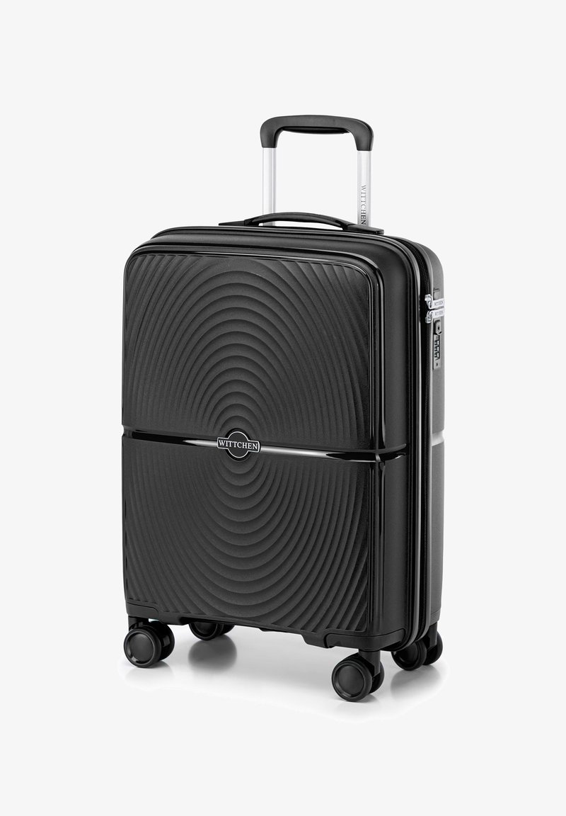 Valigia rigida nera con texture ondulata, doppie zip, manico retrattile e quattro ruote per la mobilità. Caratterizzata da un logo sul davanti.