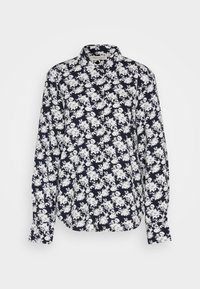 Chemise à manches longues boutonnée avec un motif floral noir et blanc et un col classique sur un fond uni.