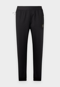 Μαύρο φαρδύ παντελόνι φόρμας με ελαστική μέση, πλαϊνή τσέπη με φερμουάρ και μικρό ορθογώνιο λογότυπο στο δεξί μηρό.