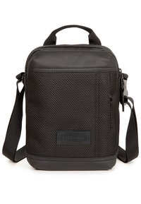 Zaino Eastpak nero con superficie texturizzata, chiusura con zip, manico superiore, tracolla rimovibile e patch logo sul davanti.