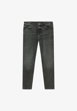 Wyblakłe czarne dżinsy w prostym kroju, z zapięciem na zamek, pięcioma kieszeniami i subtelnymi detalami w szyciu.