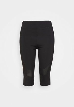 Leggings deportivos negros hasta la rodilla con cintura alta y paneles de malla sobre las rodillas, mostrados plegados sobre un fondo blanco.