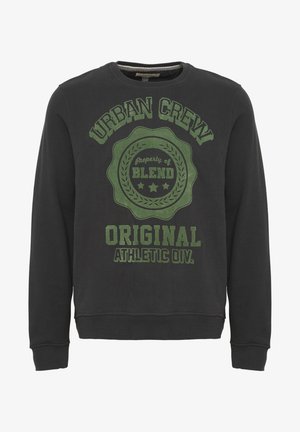 Must saadepuuduga must puuvilla särk, millel on rohelise trükiga graafika, millel on kirjad "URBAN CREW", "Property of BLEND" ja "ORIGINAL ATHLETIC DIV.".