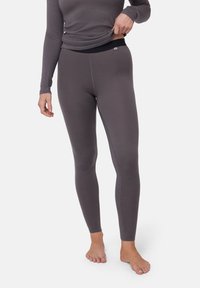 Leggings grigi realizzati in un materiale morbido e elasticizzato con un cinturino nero. Hanno una vestibilità slim e presentano cuciture a contrasto.