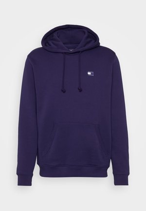 Marineblaue Kapuzenjacke mit Fronttasche, Kordelzug an der Kapuze, gerippten Bündchen und kleinem Tommy Jeans-Logo auf der linken Brust.