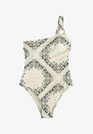 Egylapos vállú bézs fürdőruha fekete virágos bandana mintával és fa karika részlettel a pánton.