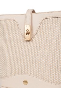 Borsa a tracolla beige intrecciata con accenti in pelle liscia, dotata di una chiusura dorata e un sottile motivo a onde, che mette in risalto il contrasto di texture e materiali.