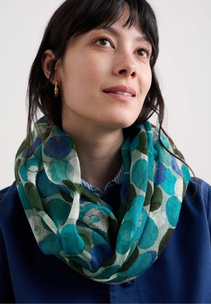 Sciarpa a infinito multicolore con motivi circolari nelle tonalità di teal, blu e verde, realizzata in un tessuto leggero e con una trama testurizzata.