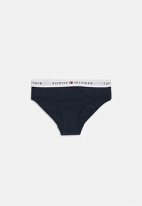 Marineblauwe katoenen slips met een witte elastische tailleband met het "TOMMY HILFIGER" logo en een rode accent op een gladde, rekbare stof.