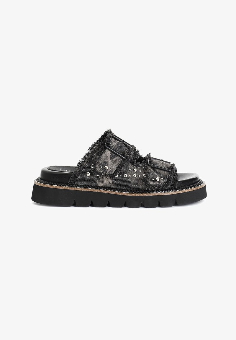 Black slide sandal with frayed denim material, decorative studs, two adjustable straps, and a thick rubber sole.