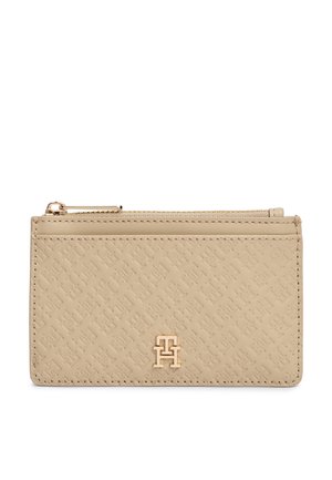 Portafoglio beige in pelle con motivo impresso, cerniera dorata in alto e emblematico logo dorato al centro davanti.