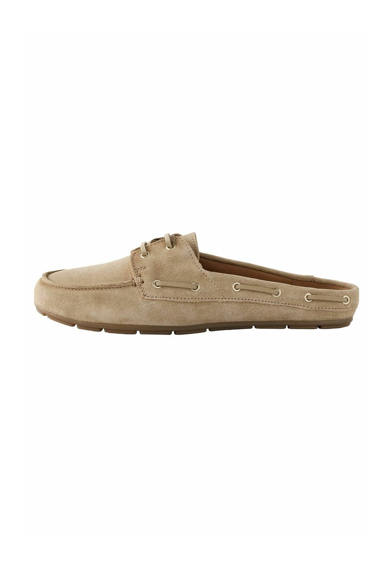 Beige suede slip-on shoe with a rounded toe, two eyelets, and a rubber sole. Features stitching detail along the edges.