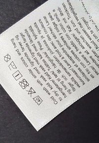 Washing instructions label with symbols for no bleach, iron low, gentle wash at 40°C, no tumble dry, and no dry clean.