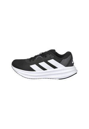 Zapatilla deportiva negra con parte superior de malla ligera, que presenta tres franjas blancas, una plantilla blanca acolchada y suela exterior de goma texturizada.