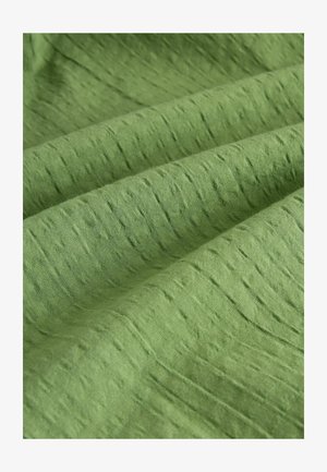 Green textured fabric with a subtle, uneven pattern and a smooth finish, suitable for clothing or upholstery applications.