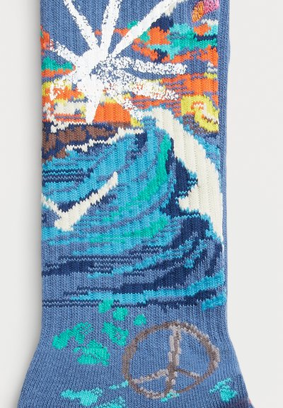 Knit socks featuring a wave and sun design in blue, orange, and green, with a peace symbol in brown at the ankle. Soft texture.