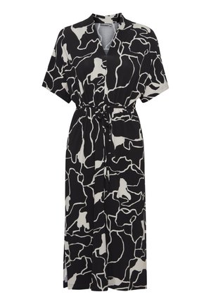 Czarna i biała sukienka o krótki rękawach z nieregularnym, abstrakcyjnym wzorem, z dekoltem w kształcie V, z dopasowaną talią i luźnym krojem. Wykonana z miękkiego materiału i sięgająca do kolan.