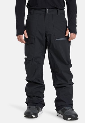 Pantalons de neige noirs en matériau résistant à l'eau, dotés d'une poche zippée, d'une taille ajustable et de genoux articulés pour faciliter les mouvements.