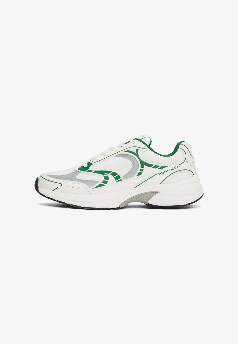 Sneaker bianche in rete con dettagli verdi e grigi. Presentano una suola spessa e un design a punta tonda, marchiato "TOMMY JEANS".