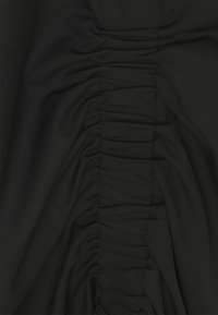 Black fabric with a textured design featuring vertical ruching along one side, creating a gathered appearance and smooth surface.