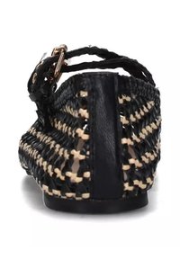 Black and beige woven flat shoe with a leather strap, showcasing a braided design and exposed texture on the sides and back.