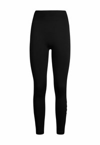 Leggings negros con una cinturilla alta, textura suave y un estilo ajustado. Sin patrones visibles ni detalles de hardware.
