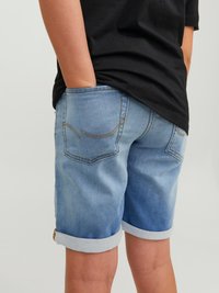 Light blue denim shorts with rolled hem, featuring back pockets and contrast stitching. Material shows slight fading for a casual look.