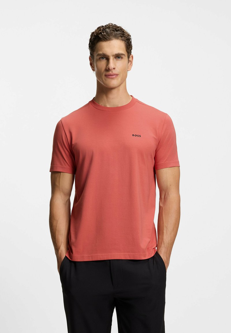 Short-sleeve, coral shirt in soft fabric with a crew neckline. Features a small "BOSS" logo on the left chest. Straight hem.
