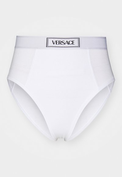 Valged puuvillased kõrge vöökohaga aluspüksid, millel on tekstureeritud riba musta "VERSACE" sildiga ja siledad pinna viimistlused.