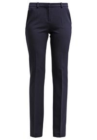 Navy blue muoti-housut, jotka on valmistettu sileästä kankaasta. Housuissa on kapea istuvuus, etutaskut ja vyölenkit, joissa on minimalistiiset suunnittelutiedot.