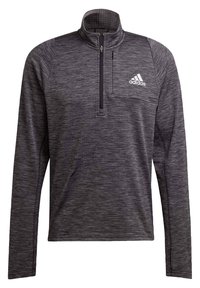 Pull-over noir à manches longues avec col à demi-fermeture éclair, en tissu texturé, doté d'une poche poitrine avant et d'un détail de logo blanc.