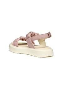 Sandalias sintéticas rosas con tiras retorcidas, una suela plana color crema y una hebilla ajustable en la parte trasera. Suela texturizada para un mejor agarre.