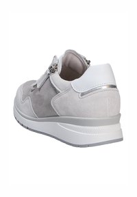 Light grey suede sneaker with a white leather heel and metallic accents. Features a zip closure and a rubber sole with textured tread.