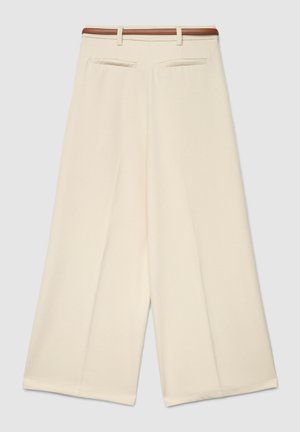 Pantaloni a gamba larga color crema a vita alta con tasche posteriori e cintura marrone, mostrati distesi su uno sfondo chiaro.