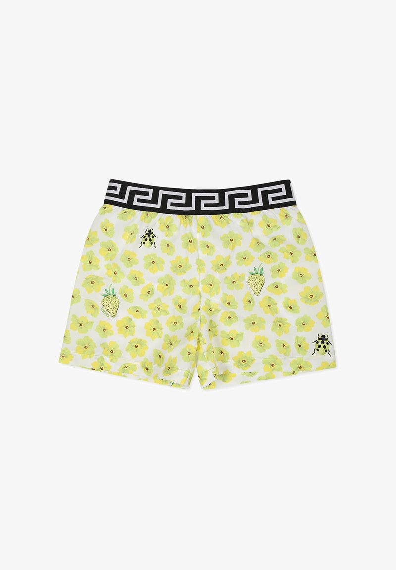 Costumi da bagno da uomo bianchi con un motivo floreale giallo, vita nera con un design geometrico e dettagli di coccinelle e fragole.